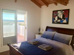 A bed or beds in a room at Cueva Romana Cave House, Clothing Optional, Adult Only
