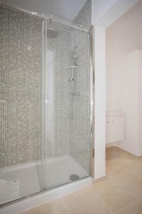 a shower with a glass door in a bathroom at Liiiving in Porto | Center Spot Apartment in Porto