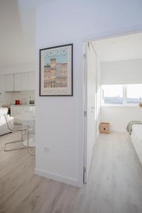 a white room with a picture on the wall at Liiiving in Porto | Center Spot Apartment in Porto