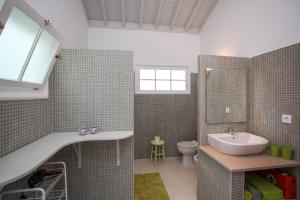 a bathroom with a sink and a toilet at Adega do Mota in Vila Franca do Campo