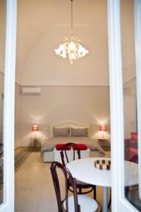a bedroom with a bed and a table and chairs at A&G House in Ceglie Messapica