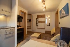 a small living room with a couch and a kitchen at Alpine Lodge in Zermatt