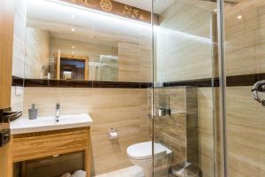 a bathroom with a toilet and a glass shower at Hotel Palatín in Oravský Podzámok