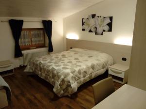 Voodi või voodid majutusasutuse Appartamento Cristallo di Ghiaccio toas