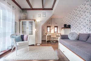 a living room with a couch and a chair at Willa Rybaczówka z ogrodem in Puck