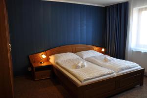 Penzion Barunka tesisinde bir odada yatak veya yataklar
