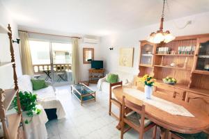 a living room with a table and a couch at Dalia in Port de Pollensa
