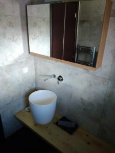 a bathroom with a sink and a mirror on a counter at Atmospherico in Karpenisi