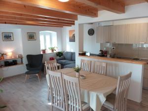 a kitchen and dining room with a table and chairs at Mediterranean stone house in Babino Polje