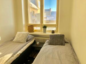 a bedroom with a bed and a window at Scandinavian Sweet home 18 Heart of City in Helsinki