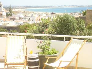 two chairs on a balcony with a view of the ocean at CasaDuarte "Balcony" (2 bedroom Apt.) in Lagos