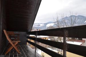 a balcony with a chair and a view of the mountains at Holiday House Bohinj in Bohinj