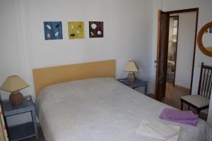 a bedroom with a bed with two tables and two lamps at CasaDuarte "Balcony" (2 bedroom Apt.) in Lagos