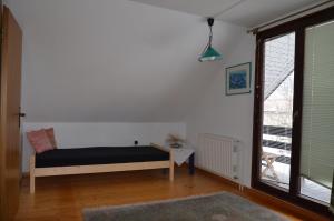 a bedroom with a bed and a large window at Holiday House Bohinj in Bohinj