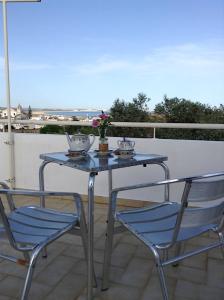 a blue table and two chairs on a balcony at CasaDuarte "Balcony" (2 bedroom Apt.) in Lagos