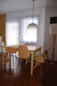 a dining room with a wooden table and chairs at Holiday House Bohinj in Bohinj