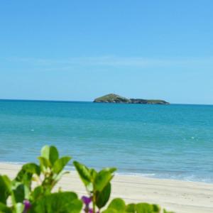 a view of the beach with an island in the water at Acuarela Hostal in Playa Blanca