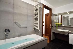 a bathroom with a tub and a sink at Colosseo Panorama in Rome