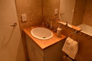 a bathroom with a sink and a toilet and a tub at Nothofagus Apartments in San Carlos de Bariloche +19 photos