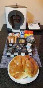 bochenek chleba na talerzu obok tostera w obiekcie A casa da Igrexa w mieście Ribadavia