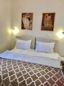 a large bed with two pillows on top of it at sea view countryside home near Athens in Nea Peramos