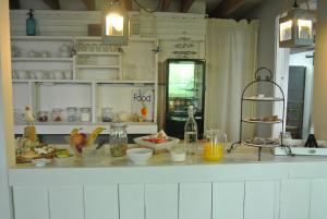 a kitchen with a counter with food on it at B&B Bouwmanshoeve in Burgh Haamstede