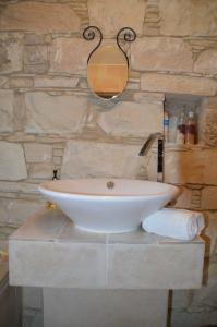 a bathroom with a white sink on a stone wall at Haven in Limassol