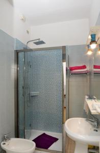 a bathroom with a shower and a sink and a toilet at Hotel Puntabella in Varazze