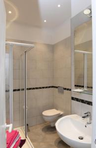 a bathroom with a toilet and a sink at Hotel Puntabella in Varazze