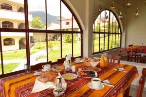 a table with food on it in a room with windows at Los Alamos in Caraz
