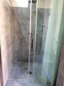a shower with a glass door in a bathroom at Napoli Central Loft in Naples