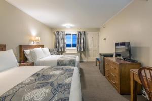 a hotel room with two beds and a television at Chebucto Inn in Halifax