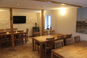a large dining room with wooden tables and chairs at Festung Märcz in Pirna
