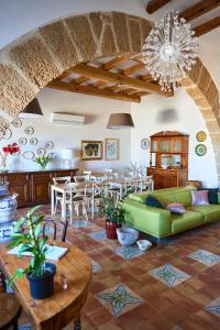 a living room with a green couch and a table at Santina in Castellammare del Golfo