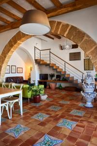 a living room with a table and a staircase at Santina in Castellammare del Golfo