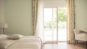 Postel nebo postele na pokoji v ubytování Hotel Magdalena