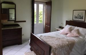 a bedroom with a bed with a dresser and a mirror at Casa Vilar in Sanxenxo +48 photos