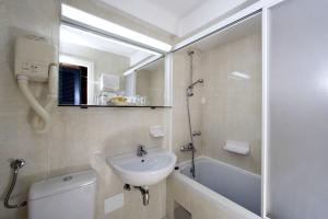a bathroom with a sink and a toilet and a shower at Apartments Bellevue Plava Laguna in Poreč