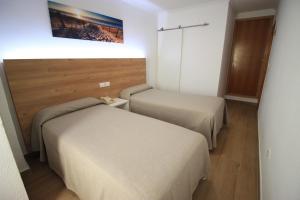 Postel nebo postele na pokoji v ubytování Hostal Pensimar
