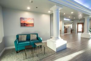 a living room with a blue couch and a table at Tamarack Beach Hotel in Carlsbad