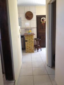 a kitchen with a tiled floor and a kitchen with a table at Casa verde in Laguna