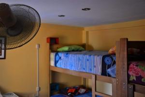1 dormitorio con 2 literas y ventilador en Suspiros del Inka en Lima