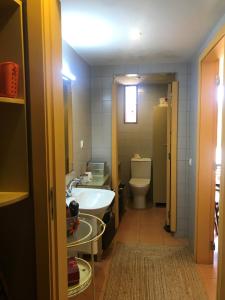 a small bathroom with a sink and a toilet at ADOBE TYPICAL COTTAGE in AlpalhÃ£o +31 photos