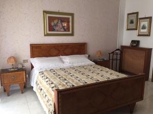 a bedroom with a large bed with two night tables at B&B DONNA PORZIA in Trani