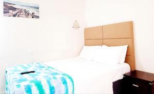 a small bedroom with a bed with at Perth City Motel in Perth