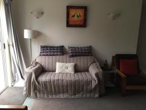 a living room with a couch with a pillow on it at Oatlands Retreat in Oatlands
