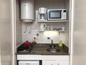 una pequeña cocina con fregadero y microondas en Dodis Studio Recoleta . to 6 Blocks from Cemetery en Buenos Aires