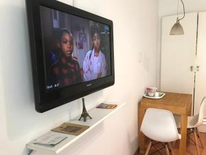 TV de pantalla plana colgada en la pared en Dodis Studio Recoleta . to 6 Blocks from Cemetery en Buenos Aires