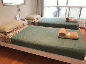 a room with three beds with towels on them at Dodis Studio Recoleta . to 6 Blocks from Cemetery in Buenos Aires