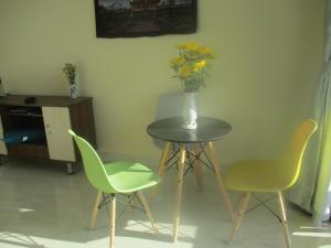 a table with two chairs and a vase with flowers on it at loue t1bis in Nha Trang